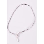 An 18ct white gold and diamond necklace of twisted ribbon form, on articulated link chain, 16.4