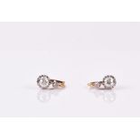A late 19th / early 20th century pair of yellow gold and diamond earrings each claw-set with an