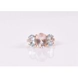 A 9ct yellow gold, morganite, and aquamarine ring set with an oval-cut morganite, approximately 10 x