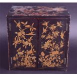 A Japanese Meiji period lacquer jewellery cabinet decorated with gilt and red lacquer scenes of