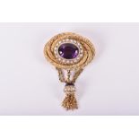 A late 19th / early 20th century yellow gold, amethyst, and seed pearl pendant of swirled design,