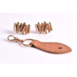 A pair of 9ct gold cufflinks each of textured stylised bark form, 19 grams; and a leather key