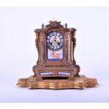 A Louis XVI style gilt metal and porcelain mounted clock the jewelled porcelain dial with roman