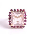 A kunzite and ruby ring the central emerald-cut kunzite weighing approximately 20.56 carats,