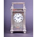 A solid silver carriage clock by Charlies Frodsham hallmarked London 1977, the white enamel dial