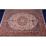 An early 20th century Heriz carpet the central medallion and field with detailed foliate patterns
