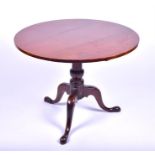A George III mahogany tilt top supper table with turned column support above three cabriole legs