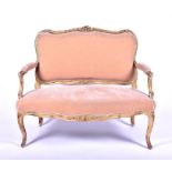 A French Louis XV style two seater salon settee designed with scrolled giltwood frame with floral