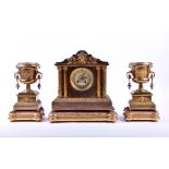 A late 19th century French Empire style brass clock garniture comprising a central clock and a