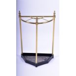A 20th century brass stick stand of demi-lune form, in the Victorian style, with an iron base, 63 cm