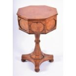 A Regency burr walnut veneered teapoy of octagonal shape, with beaded panels around, opening to