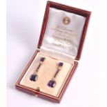 A pair of amethyst and diamond drop earrings each set with an emerald-cut amethyst, suspended