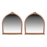An impressive pair of gilt framed arched wall mirrors the framed moulded with trailing foliate