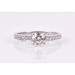 An 18ct white gold and diamond ring set with a round brilliant-cut diamond of approximately 0.70