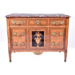 A Louis XVI marquetry and parquetry marble top commode comprising three drawers with ormolu