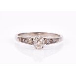 A white metal and diamond ring set with an old-cut diamond of approximately 0.33 carats, the