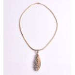 A diamond pendant of stylised teardrop form, one side composed of 14ct textured yellow gold leaf