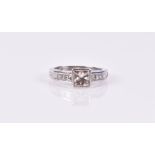 An 18ct white gold and diamond ring set with a princess-cut diamond of approximately 1.0 carats,