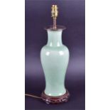 A Chinese glazed celadon porcelain lamp the ovoid shape body with floral motifs, raised on a