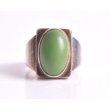 A Georg Jensen silver ring centred with a green cabochon stone, numbered 84A, size N 1/2.