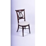 A Regency mahogany bedroom chair the drum shaped upholstered seat with fluted border on turned and