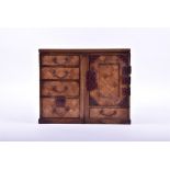 A Japanese Meji period parquetry miniature tansu cabinet designed with geometrical fruitwood