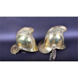 A set of two late 19th/early 20th century Merryweather & Sons brass fireman helmets each mounted