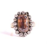 A Georgian style zircon and diamond ring centred with a rectangular cushion-cut foiled back brown