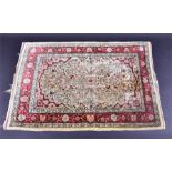 A good quality old woven silk prayer rug  the central cream field populated with symmetrical