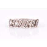 An 18ct white gold and diamond ring set with alternating round and baguette-cut diamonds, size N,