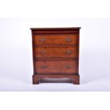 A good quality reproduction chest of three short drawers in burr veneers in the Georgian style