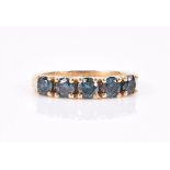 A yellow gold and blue diamond ring set with five round-cut diamonds of approximately 1.0 carat