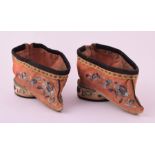 A small pair of antique Chinese embroidered silk shoes finely detailed with foliate and floral