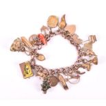 A rose metal charm bracelet the links stamped 375, suspended with various charms including a