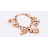 An 18ct yellow gold charm bracelet suspended with various charms, some marked 9ct, including a