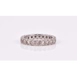 A diamond eternity ring set with round brilliant-cut diamonds of approximately 0.65 carats combined,