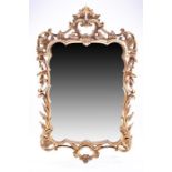 A decorative wall mirror with gilt frame in the Rococo style (A/F) 130 x 65 cm.