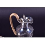 A Victorian silver embossed silver claret jug London 1894, with wooden handle, 25 cm high, 14.6 ozt,