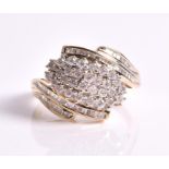 A 9ct yellow gold and diamond cluster ring of crossover style, centred with a cluster of brilliant-