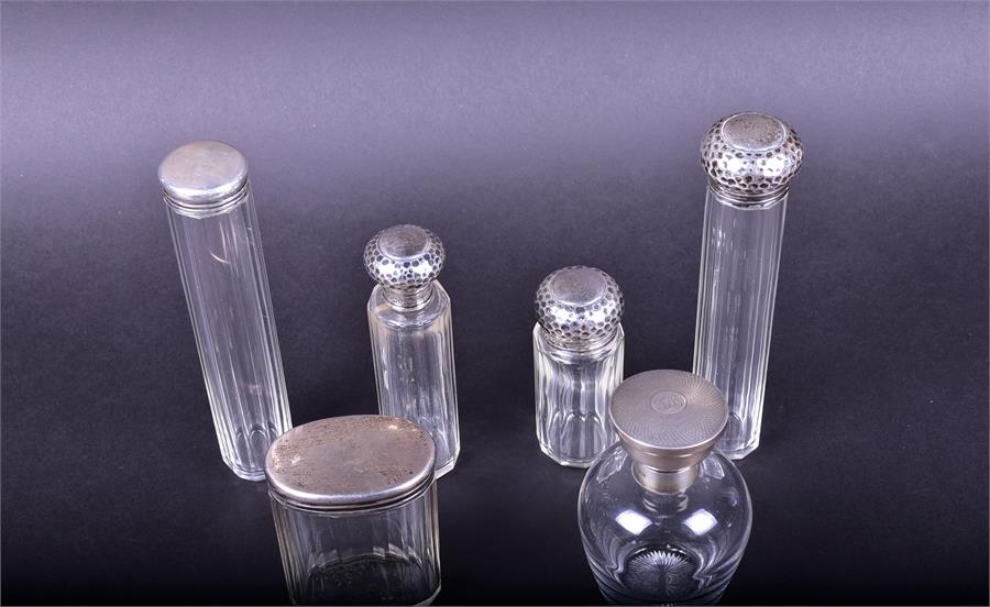 A group of silver topped dressing table bottles comprising a glass perfume bottle with engine turned - Image 2 of 2