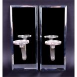 A pair of mirrored wall sconces the rectangular mirrored back panels with bevelled edges holding a