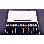 A set of 12 1960s silver and enamel demi-tasse spoons of various colours, in a fitted box.