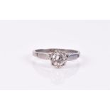 A platinum and diamond solitaire ring set with a round-brilliant cut stone of approximately 0.50