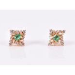 A pair of 18ct yellow gold, diamond, and emerald earrings the quatrefoil mounts set with round and