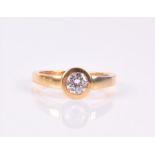 An 18ct yellow gold and diamond ring the single rubover set stone approximately 0.45 carats, size L,