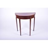 A small demi-lune side table in the Edwardian style in mahogany veneers with inlaid borders, 66 cm