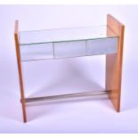 A mid century mirrored satinwood dressing table designed with a central mirrored surface above three