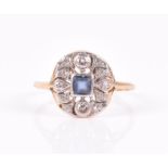 A yellow metal, diamond, and sapphire ring the openwork rounded mount centred with a square-cut