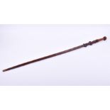 An African Ashanti carved hardwood tribal stick with carved decoration to the handle and a gently