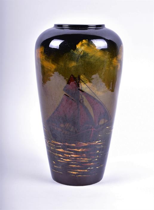 An early 20th century tall vase in the manner of Wardle with an underglaze sgrafitto continuous